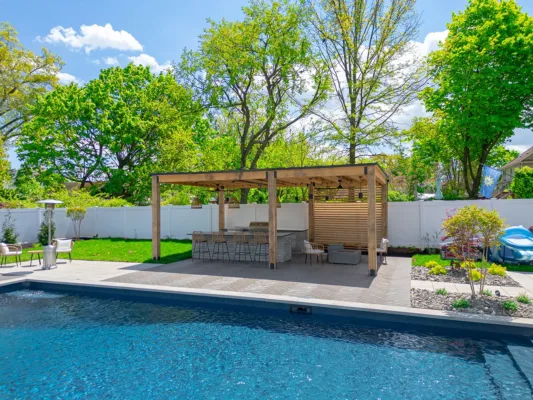 This Edison, NJ backyard was completely transformed into a stunning outdoor retreat featuring a custom pool patio, pavilion, landscape lighting, and underground water management system. The design includes durable pavers, a stylish shaded pavilion, LED lighting for ambiance and safety, and a well-planned drainage system to ensure longevity and functionality. The result is a beautiful and functional space perfect for relaxation and entertaining.